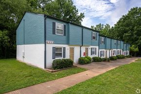 Winston-Salem apartment for rent - a blue and white building with a sidewalk in front of it