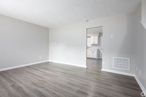 Winston-Salem apartment for rent - an empty living room with wood floors and white walls