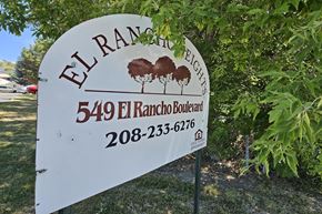 Pocatello apartment for rent - A sign for El Rancho Boulevard with a phone number on it.