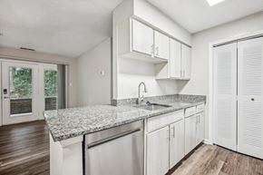 Germantown apartment for rent - A kitchen with white cabinets and a granite countertop  at Elme Germantown, Maryland, 20876