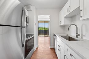 Alexandria apartment for rent - A kitchen with white cabinets and a stainless steel refrigerator  at Riverside Apartments, Alexandria, Virginia