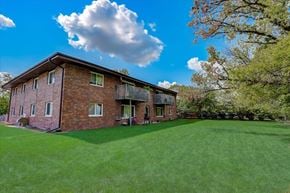 Hartland apartment for rent - a red brick house with a green lawn and trees