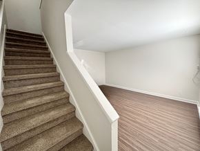 Sun Prairie townhouse for rent - A staircase with a carpeted runner and wooden steps.