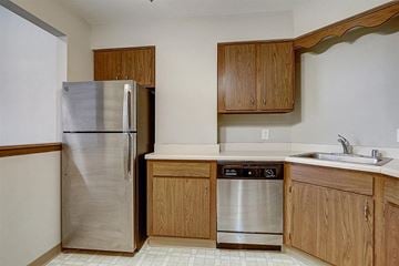 Wauwatosa apartment for rent - a kitchen with a stainless steel refrigerator and a sink