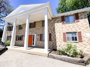 Madison apartment for rent - the front of a brick building with columns and a porch
