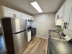Madison apartment for rent - A kitchen with a black counter top and stainless steel appliances.
