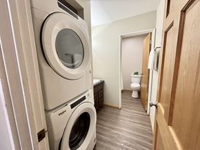 Madison apartment for rent - A laundry room with a washer and dryer stacked on top of each other.