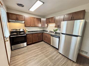 Madison apartment for rent - A kitchen with wooden cabinets and stainless steel appliances.