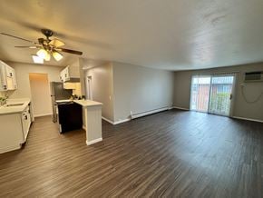 Madison apartment for rent - A room with a ceiling fan and wooden flooring.