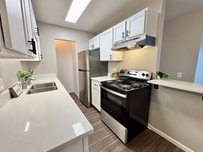 Madison apartment for rent - A modern kitchen with a stove, sink, and refrigerator.