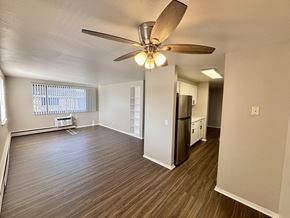 Madison apartment for rent - A room with a ceiling fan and wooden flooring.