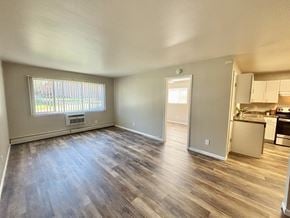 Madison apartment for rent - A room with a window and a kitchen area in the background.