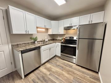 Madison apartment for rent - A kitchen with white cabinets and stainless steel appliances.