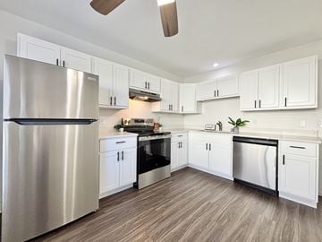 Sun Prairie townhouse for rent - A modern kitchen with a stainless steel refrigerator and wooden flooring.