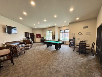 Waunakee apartment for rent - A spacious living room with a pool table and comfortable seating.