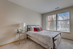 Milwaukee apartment for rent - a bedroom with a bed and a large window