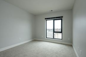 Brookfield apartment for rent - A room with a carpeted floor and a window showing a view of buildings outside.