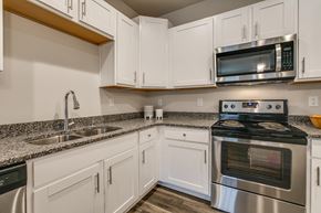 Kenosha apartment for rent - a kitchen with stainless steel appliances and white cabinets