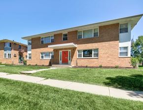 Madison apartment for rent - the front of a brick apartment building with a red door