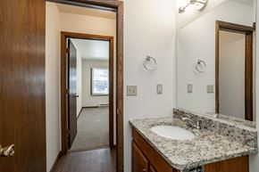 Stevens Point apartment for rent - a bathroom with a sink and a mirror and a door to a bedroom
