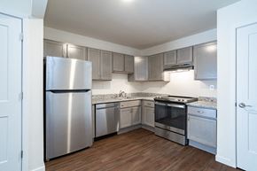 Plover apartment for rent - a kitchen with stainless steel appliances and white cabinets