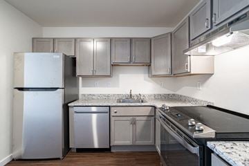 Plover apartment for rent - a kitchen with stainless steel appliances and granite counter tops