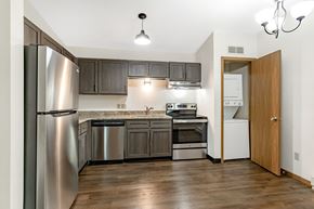 Wausau apartment for rent - a kitchen with stainless steel appliances and wooden cabinets