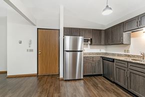 Wausau apartment for rent - an empty kitchen with a stainless steel refrigerator