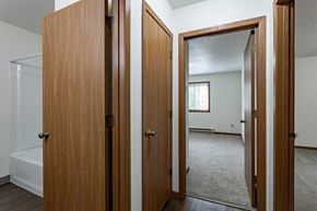 Wausau apartment for rent - an open door into a bedroom and a mirror in a house