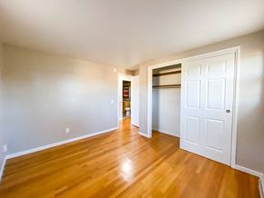 Madison apartment for rent - an empty living room with wooden floors and a white door