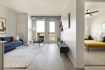Woodbury apartment for rent - A living room with a blue couch and a yellow bed.