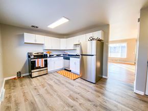 Madison townhouse for rent - an empty kitchen with stainless steel appliances and white cabinets