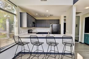 Milwaukee apartment for rent - a kitchen with a counter and three bar stools