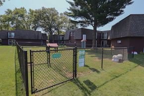 Stevens Point apartment for rent - a view of a fenced in yard in front of an apartment building
