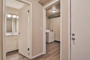Waukesha townhouse for rent - a bedroom with a door open to a bathroom with a sink and a mirror
