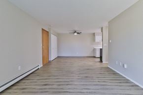 Appleton apartment for rent - an empty living room with wood flooring and a ceiling fan