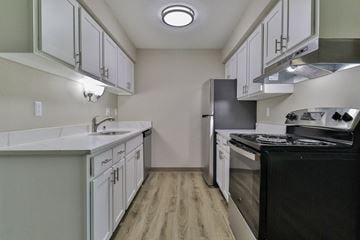 Appleton apartment for rent - the preserve at ballantyne commons apartment kitchen with white cabinets and black appliances