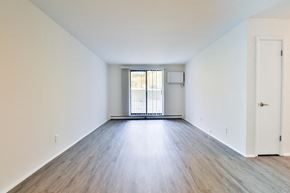Waukesha apartment for rent - an empty living room with wood flooring and a window