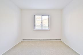 Waukesha apartment for rent - a spacious room with white walls and a window