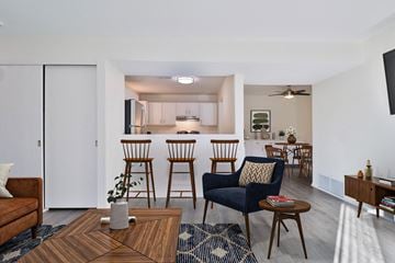 Oak Creek apartment for rent - A living room with a brown coffee table and blue chairs.