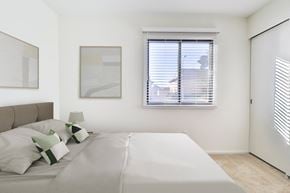 Oak Creek apartment for rent - A bedroom with a large bed and two framed pictures on the wall.