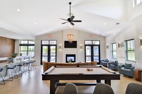 Kenosha apartment for rent - A billiard table is in the middle of a room with a pool table light.
