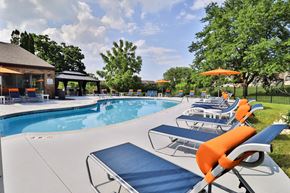 Waukesha townhouse for rent - A pool with sun loungers and a gazebo in the background.