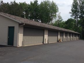 Wausau apartment for rent - A long building with a green door and a yellow dog.
