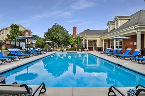 Brookfield townhouse for rent - A large swimming pool with lounge chairs and umbrellas.