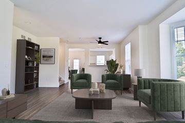 Brookfield townhouse for rent - A living room with a green chair and a grey rug.