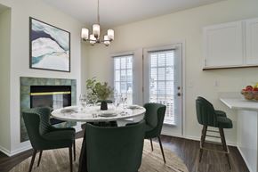 Brookfield townhouse for rent - A dining room with a white table and green chairs.