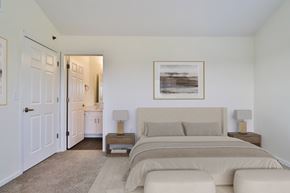 Brookfield townhouse for rent - A bedroom with a large bed and a painting on the wall.