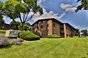 Waukesha apartment for rent - A building with a sign that says "Willisville Apartments" in front of it.