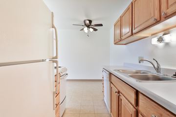 Dekalb apartment for rent - A kitchen with a white refrigerator and a white sink.